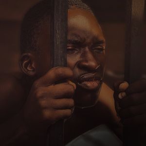 Close up of a man's hands gripping a bar.